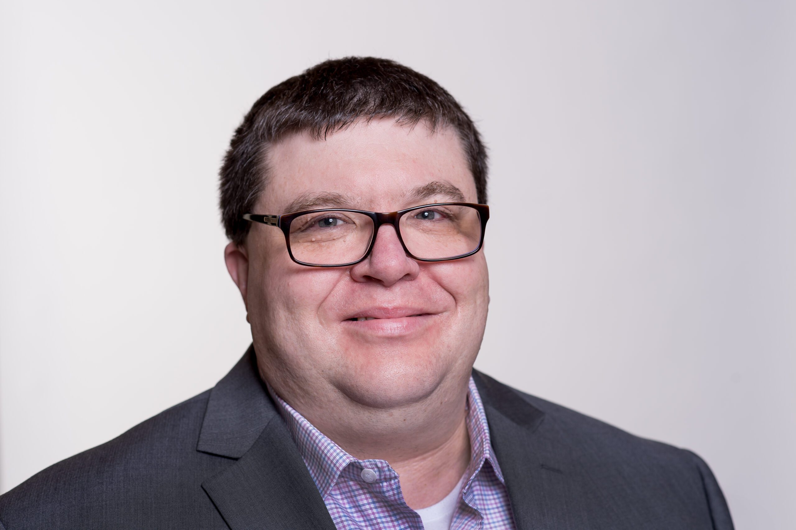 headshot of Mike Reszler wearing glasses and a suit