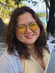 Young Filipino woman with should-length hair wearing glasses